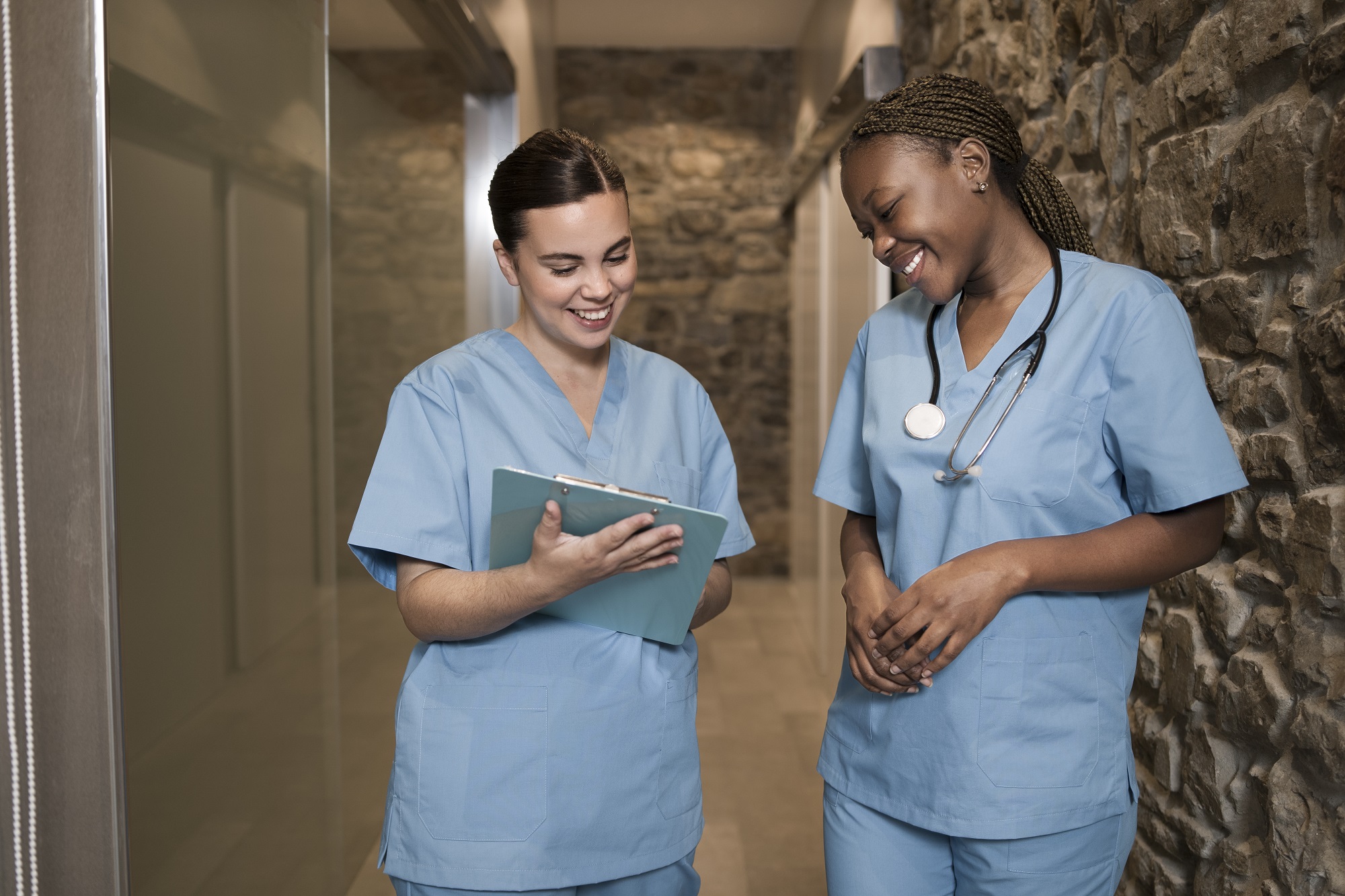 two-female-nurses-working-clinic-scrubs